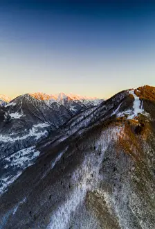 Lombardy Prints: Aerial view by drone of ski slopes of Pian Delle Betulle and Alpe Paglio lit by sunset