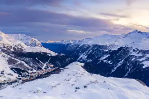 Aerial view by drone of sunset on the snowy peaks surrounding Madesimo and Andossi
