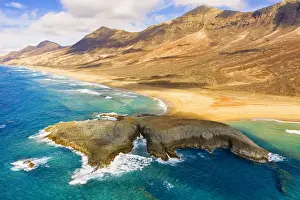 Aerial view of El Islote islet in the crystal ocean along Cofete beach, Jandia