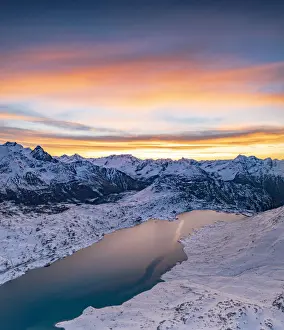 Mountain Pass Prints: Aerial view of frozen lake Lago Bianco at Bernina mountain pass covered with snow