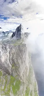 2 People Prints: Aerial view of two hikers walking towards the scenic Segla Mountain in a sea of clouds