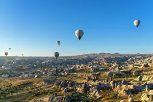 Rugged Terrain Prints: Aerial view of hot air balloons over rock formations at sunrise