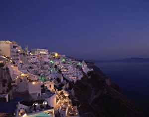 Fira Prints: Aerial view over the illuminated houses of Fira Town at dusk