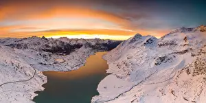 Mountain Pass Prints: Aerial view of Lago Bianco and Bernina Pass road crossing the snowcapped mountains
