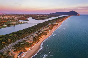 Latina Province Prints: Aerial view of the lake and beach of Sabaudia with the woody mountain of Circeo in the background at dusk