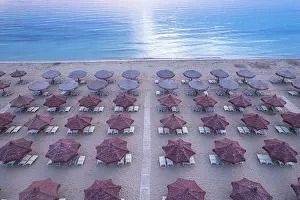 Sun Lounger Prints: Aerial view of large group of tidy beach umbrellas facing the Mediterranean Sea