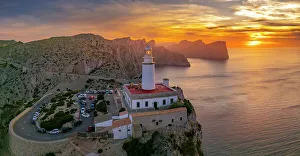 Island Hopping Prints: Aerial view of lighthouse at Cap Formentor at sunset