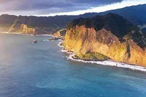 Aerial view of majestic cliffs and coastline at sunrise from Guindaste viewpoint, Faial