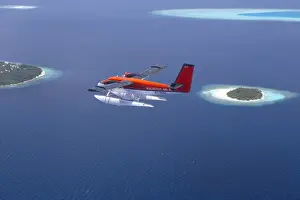 Maldives Prints: Aerial view of Maldivian air taxi flying above islands in the Maldives