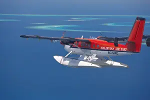 Access Prints: Aerial view of Maldivian air taxi flying in the Maldives archipelago, Indian Ocean, Asia