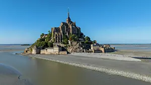 Visitors Prints: Aerial view of Mont St. Michel showcasing its architecture and the surrounding landscape during clear weather in France