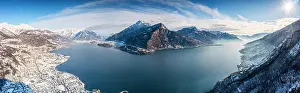 Monte Prints: Aerial view of Monte Legnone and the snowy village of Dongo, Lake Como, Lombardy, Italy