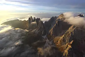 Top Of The World Prints: Aerial view of the mountain range of Odle surrounded by clouds in the Dolomites, Val Funes