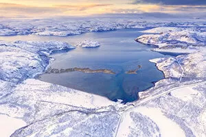 Arctic Gallery: Aerial view of Norwegian County Road 98 along snowy mountains above Laksefjorden, Lebesby