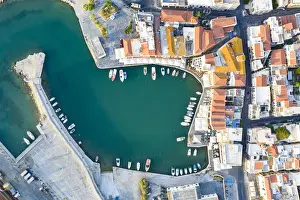 Directly Above Prints: Aerial view of the old town and Venetian harbour overlooking the blue Aegean Sea