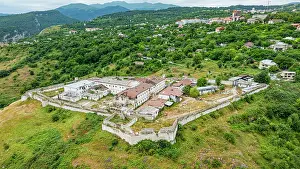 Facilities Prints: Aerial view of a former prison site surrounded by greenery in Qarabaqh region of Azerbaijan showcasing remnants of past