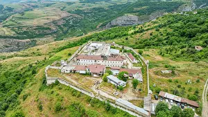 Dirt Prints: Aerial view of a former prison site surrounded by hills and greenery in Qarabaqh