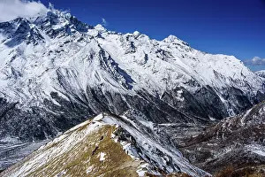 Glacial Prints: Aerial view of ridgeline leading toward rugged snow-covered mountains above Langtang Valley near Kyanjin Gompa