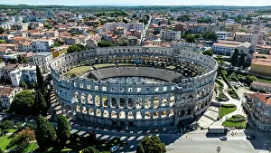 Roads Prints: Aerial view of Roman amphitheatre in Pula showing city layout and surrounding areas in Istria