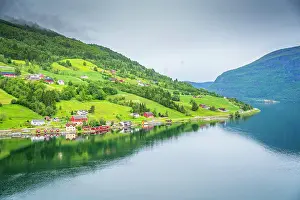 Scandinavian Prints: Aerial view of shoreline near Olden village and mountains in Nordfjorden during summer