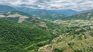 Ecology Prints: Aerial view showcases a vast canyon surrounded by hills in a rural area of Azerbaijan during overcast weather