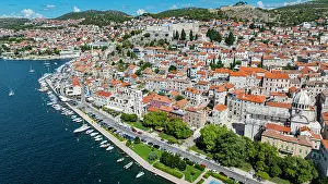 Yachts Prints: Aerial view shows colorful buildings along the waterfront in Sibenik Croatia showcasing the city's layout