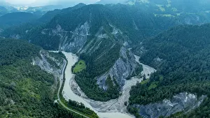 Flowing Prints: Aerial view shows the curves of the Rhein gorge in Switzerland surrounded by green hills and rocky formations
