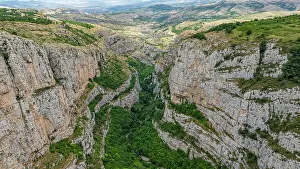 Canyon Prints: Aerial view shows the large canyon with rocky cliffs and green vegetation in the area of Shusha