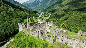 Land Prints: Aerial view shows Mesocco castle ruins surrounded by mountains and greenery in Switzerland