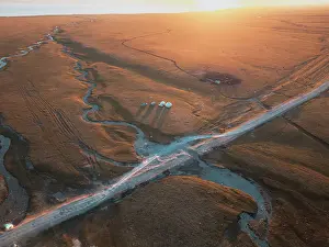 Pastoral Prints: An aerial view of the Song Kol lake area at sunrise, Kyrgyzstan