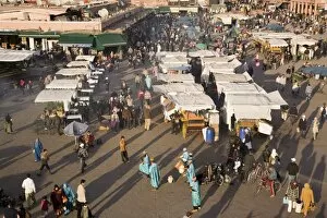 Aerial view of s talls , people and entertainers in bus y Djemma el Fna s quare in the Medina