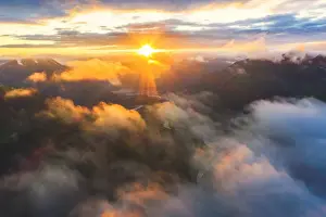 Sunbeam Prints: Aerial view of sun rays at sunset lighting up the clouds over Romsdalen valley, Andalsnes