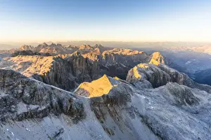 Odle Prints: Aerial view of sunset over Sella Group and Odle mountain range in autumn, Val Gardena