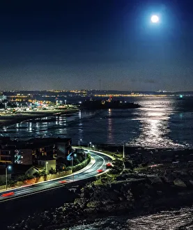 Night Sky Prints: Aerial view of the super full moon over the Tagus River in Lisbon, Portugal, Europe