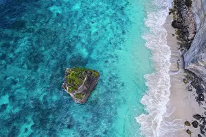 Bali Prints: Aerial view of Suwehan white sandy beach with turquoise sea water and the big rock (sea stack)