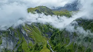 Fresh Prints: Aerial view of Tschinglengorge in Sardona National Park showing rocky slopes and cloud cover in Switzerland