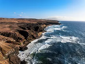Saltwater Prints: Aerial view of volcanic landscape surrounding La Pared beach washed by waves at sunset