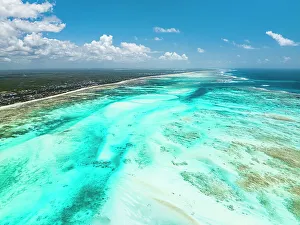 Lagoons Prints: Aerial view of white coral sand of a blue lagoon at low tide