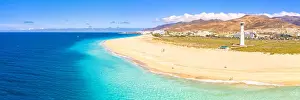Aerial view of the white sand beach and lighthouse of Morro Jable, Fuerteventura