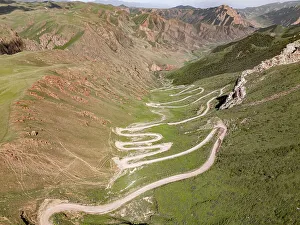 Scenic Landscape Prints: Aerial view of a winding mountain road curves
