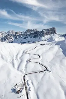 Mountain Pass Prints: Aerial view of winding mountain road in the snow and Lastoi De Formin, Giau Pass