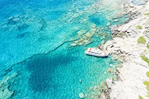 Sailboats Prints: Aerial view of yacht moored in the crystal clear sea