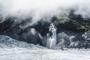 Fox Glacier Prints: Aerial of a waterfall flowing into the icefield of Fox Glacier