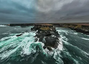 Aerial of the wild coastline with basalt pools on the Atlantic coastline, Dombe Grande, Namibre, Angola, Africa