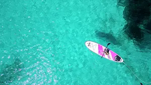 Fitness Prints: Aerial of a young girl paddling on a SUP on the Formentor Peninsula