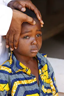 Boys Prints: African child blessed by a priest, Lome, Togo, West Africa, Africa