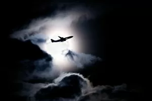 Aircraft taking off from Heathrow passing in front of full moon, London