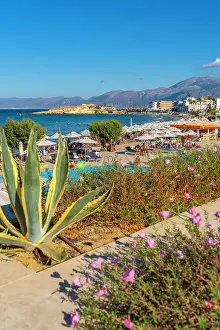 Umbrellas Prints: Akti Navarchou Nearchou Beach shows visitors enjoying sun and water activities in Limenas Chersonisou Crete Greece
