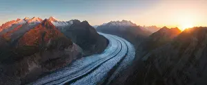 Glacier Prints: Aletsch Glacier stretches majestically as sunlight breaks over the peaks in summer from Riederalp