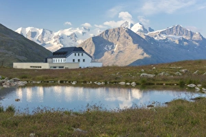 Muottas Muragl Prints: The alpine lake frames the hotel surrounded by peaks